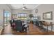 Comfortable living room with hardwood floors, ample natural light, and views of the lake and surrounding landscape at 4321 Via Del Santi Dr, Venice, FL 34293
