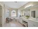 Luxurious bathroom featuring a soaking tub, double vanity, and a separate shower at 4321 Via Del Santi Dr, Venice, FL 34293