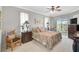 Serene main bedroom featuring a ceiling fan, access to the lanai, and views of the lake at 4321 Via Del Santi Dr, Venice, FL 34293