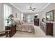 Bright main bedroom with large windows, comfortable furnishings, and views of the lake and surrounding area at 4321 Via Del Santi Dr, Venice, FL 34293