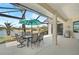 Covered patio with grill and view of lake at 4321 Via Del Santi Dr, Venice, FL 34293