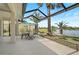 Covered patio with seating and a view of lake at 4321 Via Del Santi Dr, Venice, FL 34293