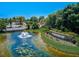 Scenic water feature with a fountain and lush landscaping welcomes you to the Venezia community at 4321 Via Del Santi Dr, Venice, FL 34293