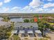 An aerial view of the condominium featuring covered parking and a serene lake backdrop on a sunny day at 442 Sunset Lake Blvd # 104, Venice, FL 34292