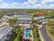 A high-angle view showcasing the condo's pool and surrounding greenery in a tranquil lakeside setting at 442 Sunset Lake Blvd # 104, Venice, FL 34292