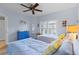 Cozy bedroom with two white beds, striped bedding, shutters, and blue accent furniture at 442 Sunset Lake Blvd # 104, Venice, FL 34292