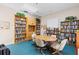 Inviting community room with bookshelves and table at 442 Sunset Lake Blvd # 104, Venice, FL 34292