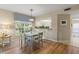 Bright dining area features hardwood floors, a garden view, and stylish decor at 442 Sunset Lake Blvd # 104, Venice, FL 34292