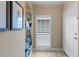 Bright foyer with tiled flooring featuring a plantation-shuttered window and front door at 442 Sunset Lake Blvd # 104, Venice, FL 34292