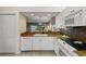 Charming kitchen featuring granite countertops, white cabinetry, and stainless steel appliances at 442 Sunset Lake Blvd # 104, Venice, FL 34292