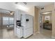 Bright kitchen featuring white appliances and cabinetry with an easy flow into the living area at 442 Sunset Lake Blvd # 104, Venice, FL 34292