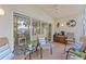Enclosed lanai offering comfortable seating and views of the lake and landscaped grounds at 442 Sunset Lake Blvd # 104, Venice, FL 34292