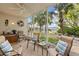 Screened lanai featuring comfortable seating and serene views of the lake and lush landscaping at 442 Sunset Lake Blvd # 104, Venice, FL 34292