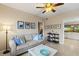 Spacious living room with tiled floors, comfortable seating, and access to the kitchen at 442 Sunset Lake Blvd # 104, Venice, FL 34292