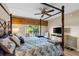 Serene main bedroom with four poster bed, ceiling fan, and views of the outside at 442 Sunset Lake Blvd # 104, Venice, FL 34292