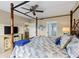 Comfortable main bedroom features a four poster bed, and ensuite bathroom at 442 Sunset Lake Blvd # 104, Venice, FL 34292