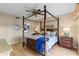 Beautiful main bedroom boasts a four poster bed, ensuite bathroom, and ample closet space at 442 Sunset Lake Blvd # 104, Venice, FL 34292