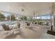 Spacious screened patio with multiple seating areas and ceiling fans, perfect for relaxing outdoors at 442 Sunset Lake Blvd # 104, Venice, FL 34292
