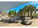 Outdoor picnic area with stone tables and benches, shaded by palm trees, near the beach at 442 Sunset Lake Blvd # 104, Venice, FL 34292