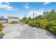 Spacious backyard features gravel, chairs, and lush landscaping under a bright blue sky at 4531 Crystal Rd, Venice, FL 34293