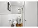 Bright bathroom features wainscoting, sleek fixtures, and classic design at 4531 Crystal Rd, Venice, FL 34293