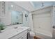 Bright bathroom featuring a shower-tub combo, charming decor, and a large mirror at 4531 Crystal Rd, Venice, FL 34293
