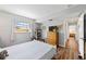 Bedroom with wood-look flooring, window view, and easy access to other rooms at 4531 Crystal Rd, Venice, FL 34293