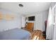 Tranquil bedroom with wood-look floors, TV, and bright light at 4531 Crystal Rd, Venice, FL 34293