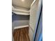 Spacious walk-in closet with built-in shelving and attractive wood-look flooring at 4531 Crystal Rd, Venice, FL 34293