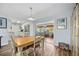 Dining area adjacent to the kitchen with hardwood floors and sliding doors leading to the exterior at 4531 Crystal Rd, Venice, FL 34293