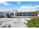 Home exterior with rock yard, an enclosed porch, and mature landscaping at 4531 Crystal Rd, Venice, FL 34293