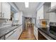 Modern kitchen with white cabinets, granite countertops, stainless steel appliances and hardwood floors at 4531 Crystal Rd, Venice, FL 34293