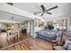 Inviting living room flows into dining area with beautiful wood-look floors and neutral decor at 4531 Crystal Rd, Venice, FL 34293