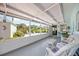 Enclosed porch with comfortable wicker seating, offering serene backyard views at 4531 Crystal Rd, Venice, FL 34293
