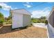 Backyard shed painted in pale green with double doors surrounded by landscaping and mulch at 4531 Crystal Rd, Venice, FL 34293