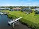 An aerial view shows the home with a private dock, located on the water with Gulf access at 5035 Collingswood Blvd, Port Charlotte, FL 33948