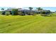 Well-maintained lawn and landscaping enhance the appeal of this home's backyard at 5035 Collingswood Blvd, Port Charlotte, FL 33948