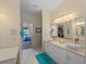 Bright bathroom featuring double sinks, vanity area, and tile flooring at 5035 Collingswood Blvd, Port Charlotte, FL 33948