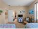Bedroom with a view of the ensuite bathroom, coastal decor, a TV, and a comfortable seating area at 5035 Collingswood Blvd, Port Charlotte, FL 33948