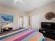 Bedroom with colorful bedding, an ensuite bathroom, a walk-in closet, and a TV for relaxing evenings at 5035 Collingswood Blvd, Port Charlotte, FL 33948