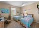 Bright bedroom with two twin beds, vibrant quilts, and beach-themed decor for a relaxing vacation ambiance at 5035 Collingswood Blvd, Port Charlotte, FL 33948