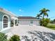Spacious driveway and a well-manicured front yard create a welcoming entrance to this home at 5035 Collingswood Blvd, Port Charlotte, FL 33948