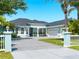 Beautiful blue home featuring an expansive driveway, well manicured lawn, and attached two-car garage at 5035 Collingswood Blvd, Port Charlotte, FL 33948
