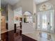 Bright and open foyer leading to the dining room, featuring elegant tile and wood flooring at 5035 Collingswood Blvd, Port Charlotte, FL 33948
