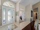 Spacious foyer with elegant front door and tile detail, opening to living and office spaces at 5035 Collingswood Blvd, Port Charlotte, FL 33948