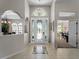 Inviting foyer showcasing decorative front door, opening to dining and living areas at 5035 Collingswood Blvd, Port Charlotte, FL 33948