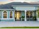 Close up of the home's arched windows, decorative door, and comfortable seating area at 5035 Collingswood Blvd, Port Charlotte, FL 33948