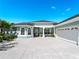 Charming single-story home featuring a two-car garage, covered entry, and light blue exterior at 5035 Collingswood Blvd, Port Charlotte, FL 33948