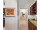Hallway featuring a wine rack on the right side and view to the kitchen on the left at 5035 Collingswood Blvd, Port Charlotte, FL 33948