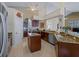 Bright kitchen with an island, granite countertops, and stainless-steel appliances is the heart of the home at 5035 Collingswood Blvd, Port Charlotte, FL 33948